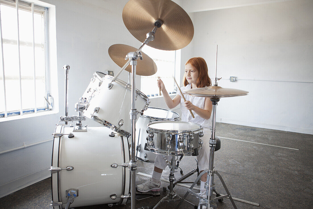Girl plays drum kit