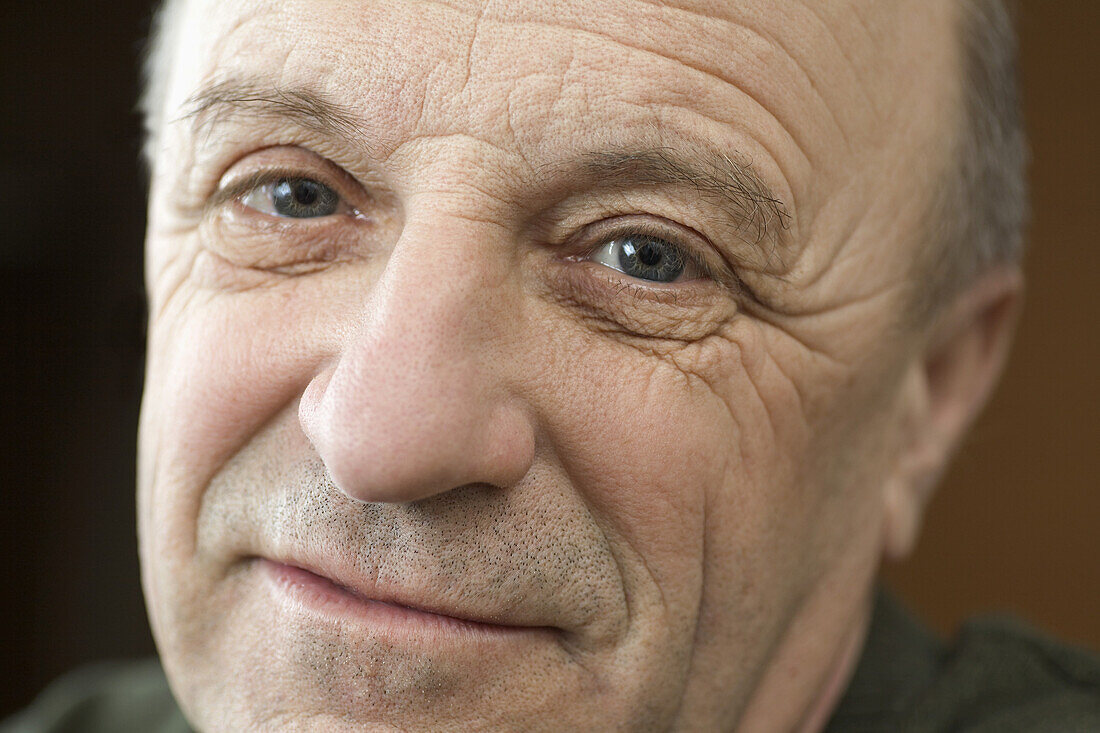 A senior man looking optimistic, close-up