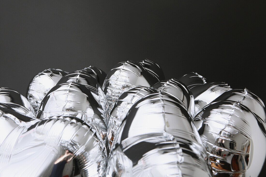 A bunch of silver helium balloons