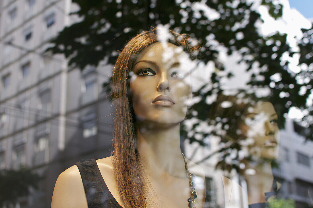 Mannequins looking at the street buildings
