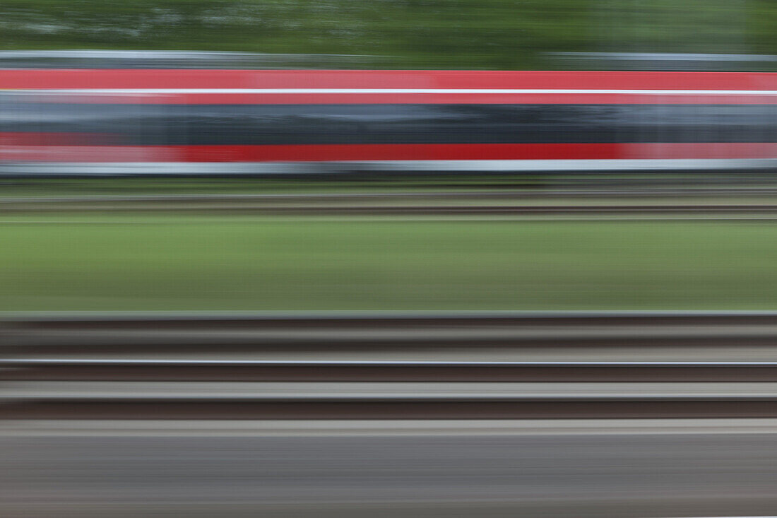Railroad tracks and a train, blurred motion, viewed from a moving train