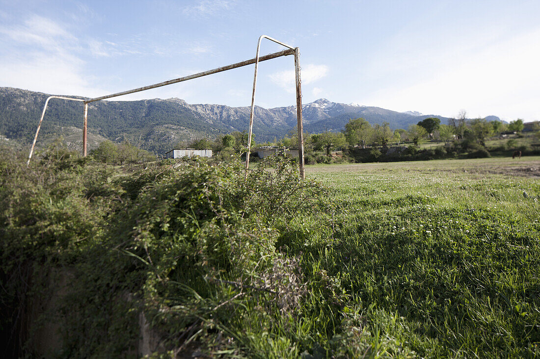 An old soccer goal post, mountains in background, Calacuccia, Corsica, France