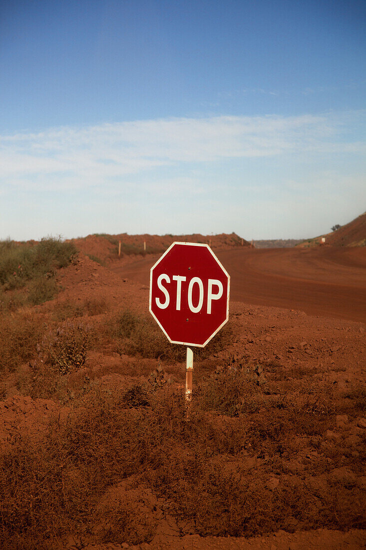 A stop sign at an intersection in a desert