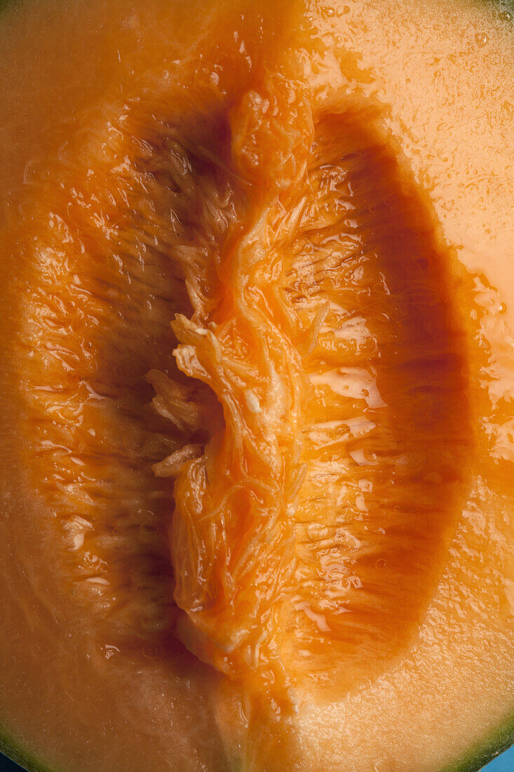 A juicy slice of cantaloupe that is suggestive of female genitalia