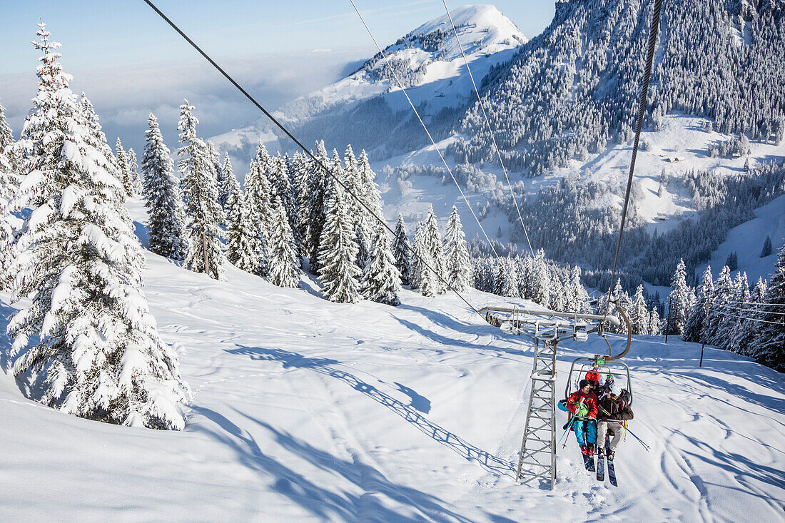 Skiers on a chair lift, free ride skiing area Haldigrat, Niederrickenbach, Oberdorf, Canton of Nidwalden, Switzerland