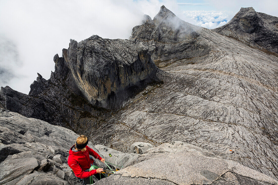 Two persons climbing the last 3 pitch of the new climbing route on Victoria Peak, Mount Kinabalu, Borneo, Malaysia.