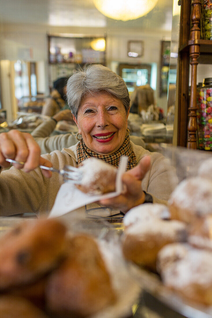 Maria Zanucco serves sweet pastries at Rosa Salva, famous café, Venice, Italy
