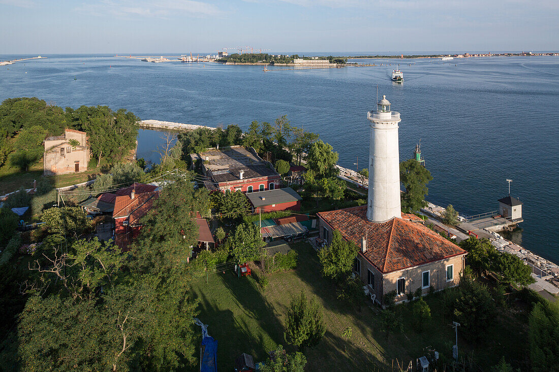 View above old Alberoni lighthouse and the pilot station at the Malamocco exit, end of the Lido, background MOSE, Lagoon, Venice, Italy