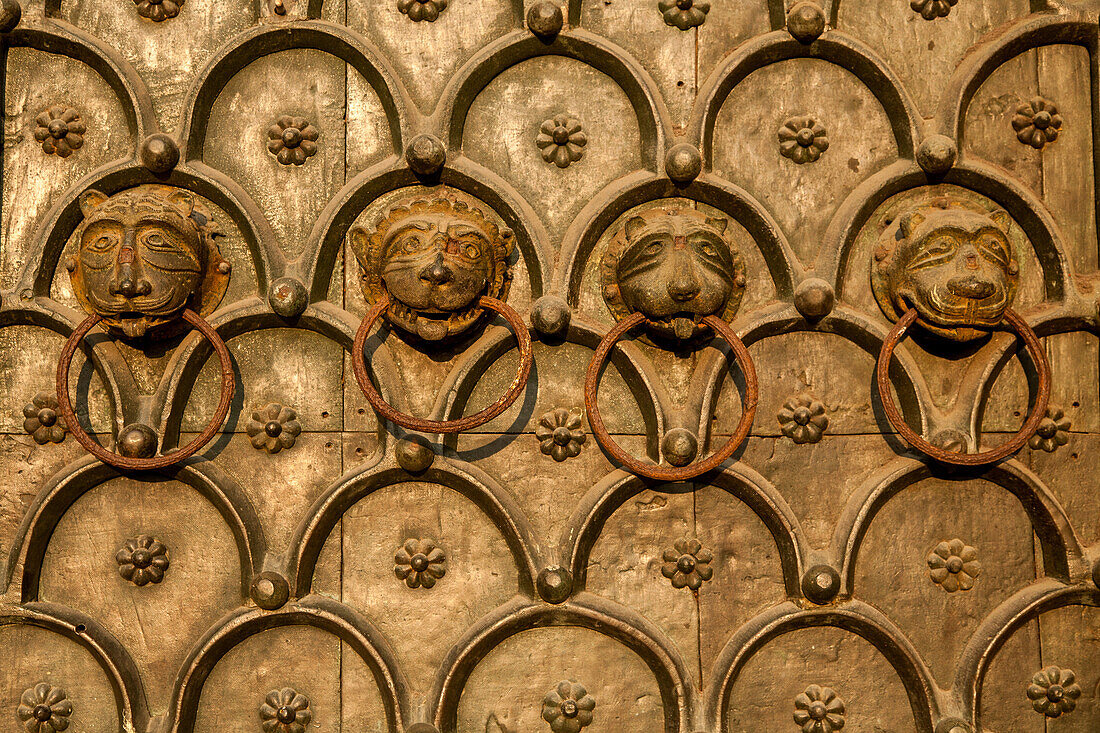 detail of lion's heads on main bronze doors Saint Mark's Basilica, decorative, symbols, animals, Venice Italy