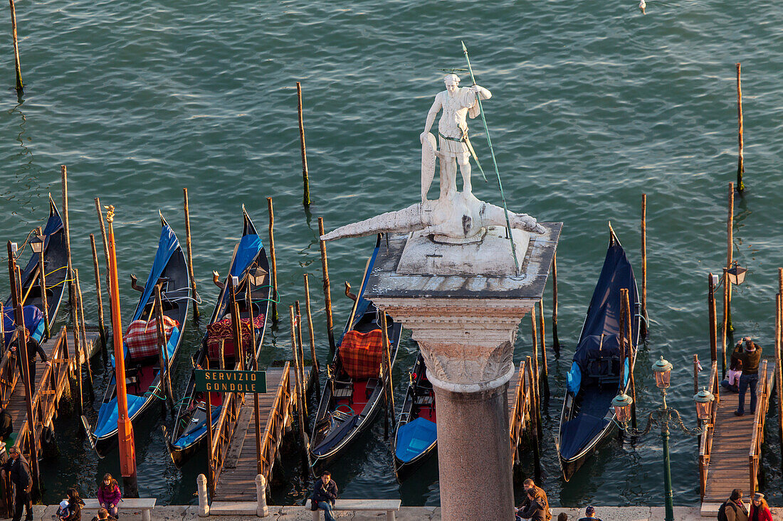 high view of Gondolas, Saint Mark's Square, Biblioteca, column, Saint Theodore, Piazzetta, Molo, historic main water entrance to Venice, Italy