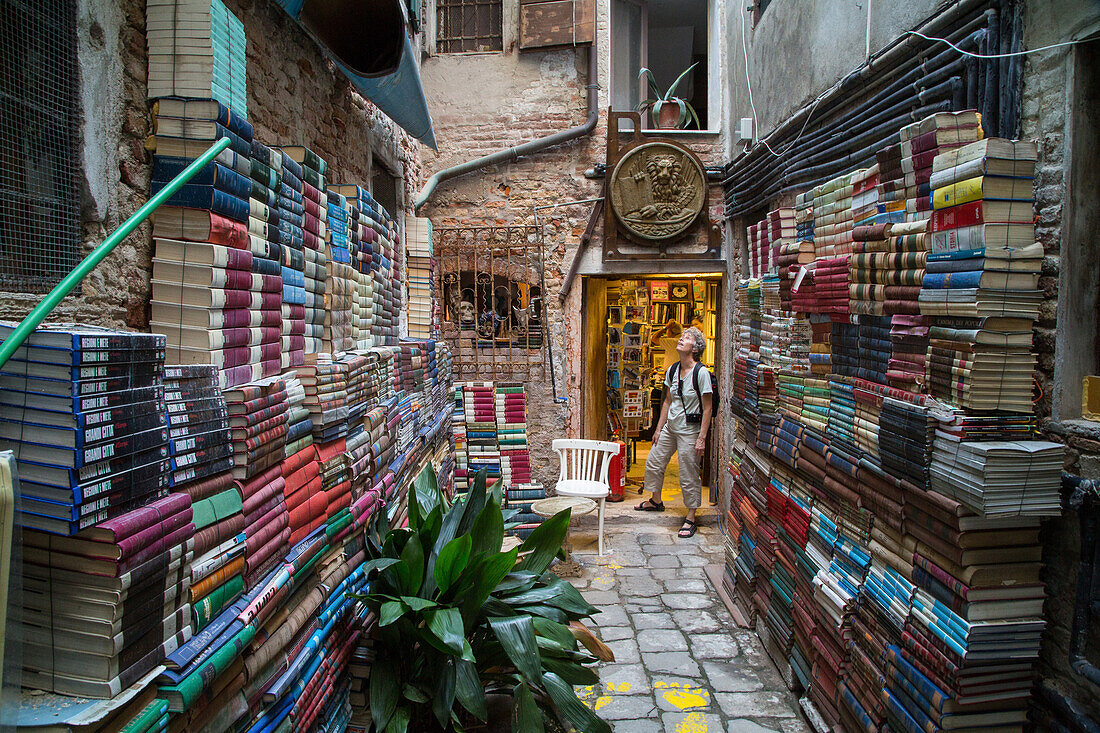 Luigi Frizzo, bookshop Libreria Acqua Alta, piles of books, Venice, Italy