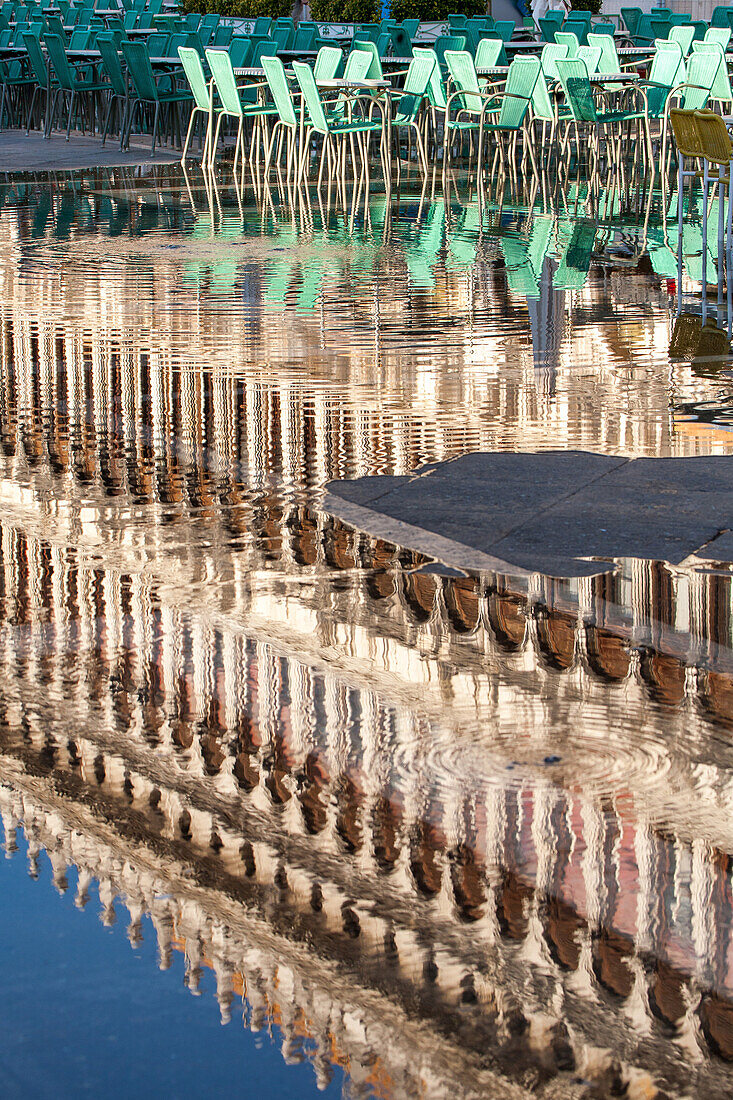 water, reflections, cafe chairs, Acqua alta St Mark's Square, San Marco, high water caused by Sirocco wind and full moon, rain in Venice, Italy