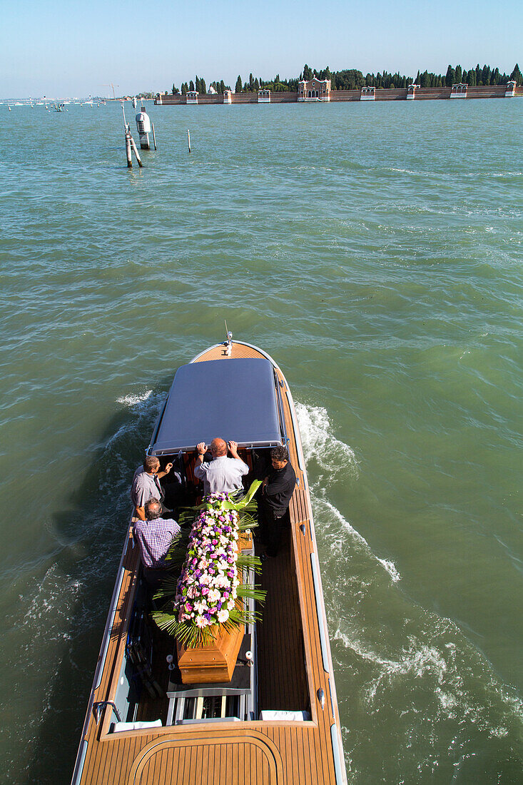 view above boat with coffin, flowers going to cemetery, San Michele, lagoon Venice, Italy