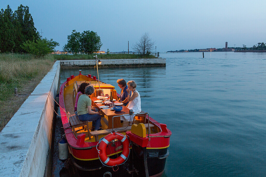 Cristina della Toffola, traditional wooden, Venetian boat, barge, Bragozzo, yellow, red, tours of the lagoon, berthed Sant'Andrea Island for dinner, Venice, Italy