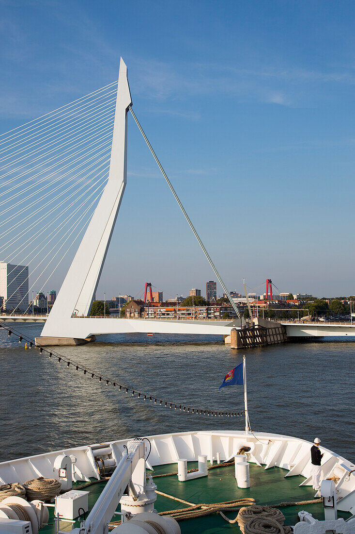 Bow of cruise ship MS Deutschland (Reederei Peter Deilmann) on Nieuwe Maas river with Erasmus Bridge, Rotterdam, South Holland, Netherlands