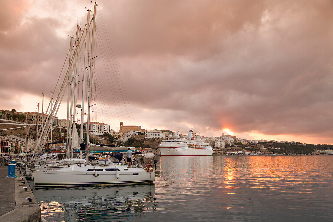 Sailing boats in the marina and cruise ship MS Deutschland (Reederei Peter Deilmann) at pier at sunset, Mahon, Menorca, Balearic Islands, Spain