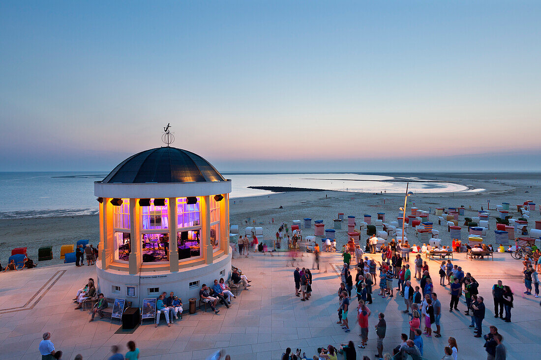 Concert at the illuminated pavilion on the beach promenade, Borkum, Ostfriesland, Lower Saxony, Germany