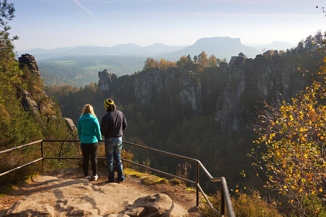 Hikers at lookout point, view over Wehlgrund to Bastei rocks, Lilienstein in the background, National Park Saxon Switzerland, Elbe Sandstone Mountains, Saxony, Germany