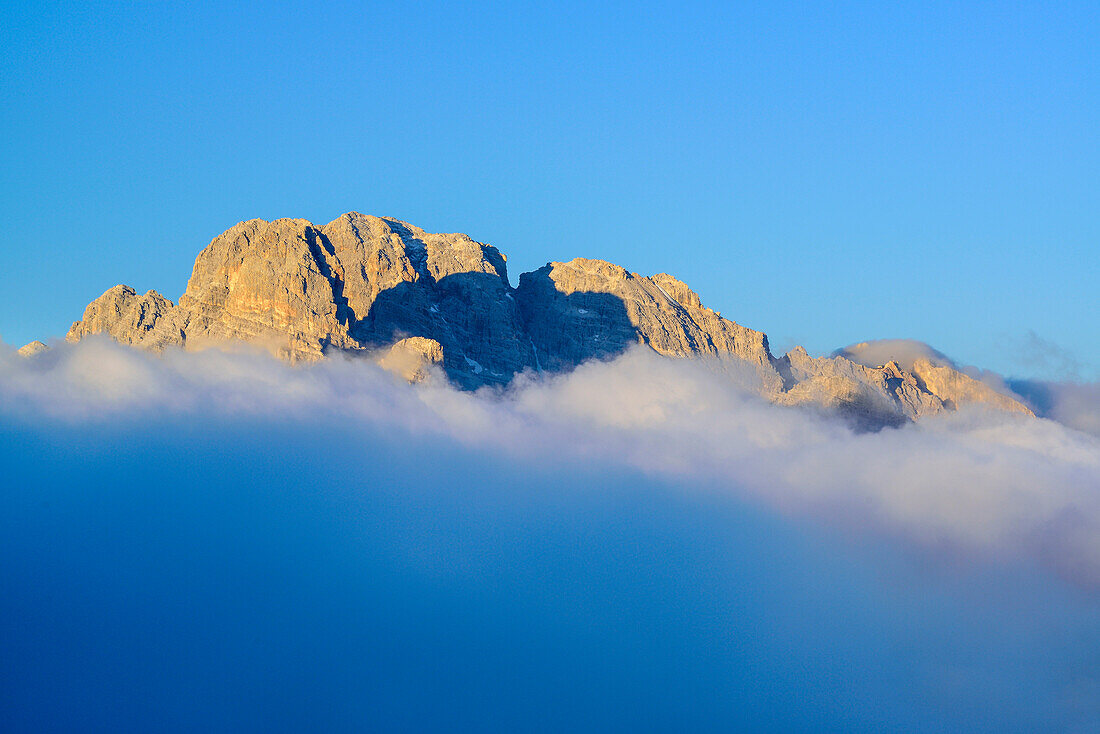 Monte Cristallo emerging from clouds, alpine hut Auronzo-Huette, Drei Zinnen, Tre Cime di Lavaredo, UNESCO World Heritage Site Dolomites, Dolomites, Veneto, Italy