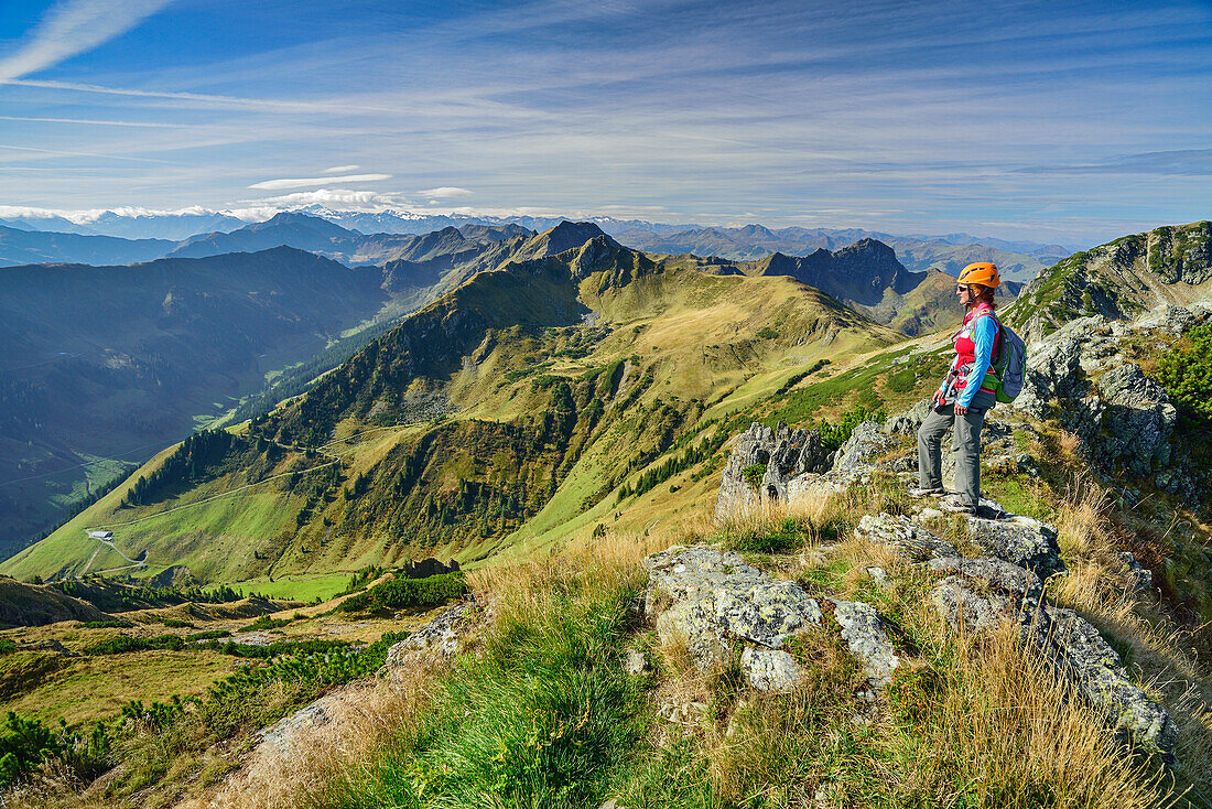Woman ascending ridge towards Henne, fixed rope route Henne, Henne, Kitzbuehel range, Tyrol, Austria