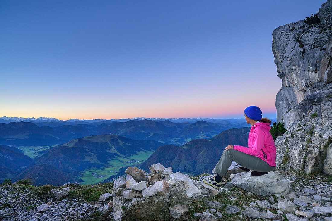 Woman sitting for a rest on the Nurracher Hoehenweg with view to Hohe Tauern range, Nurracher Hoehenweg, Loferer Steinberge range, Tyrol, Austria