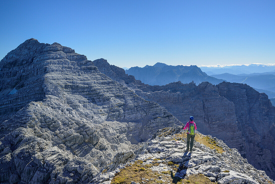 Woman hiking towards Mitterhorn, Nurracher Hoehenweg, Loferer Steinberge range, Tyrol, Austria