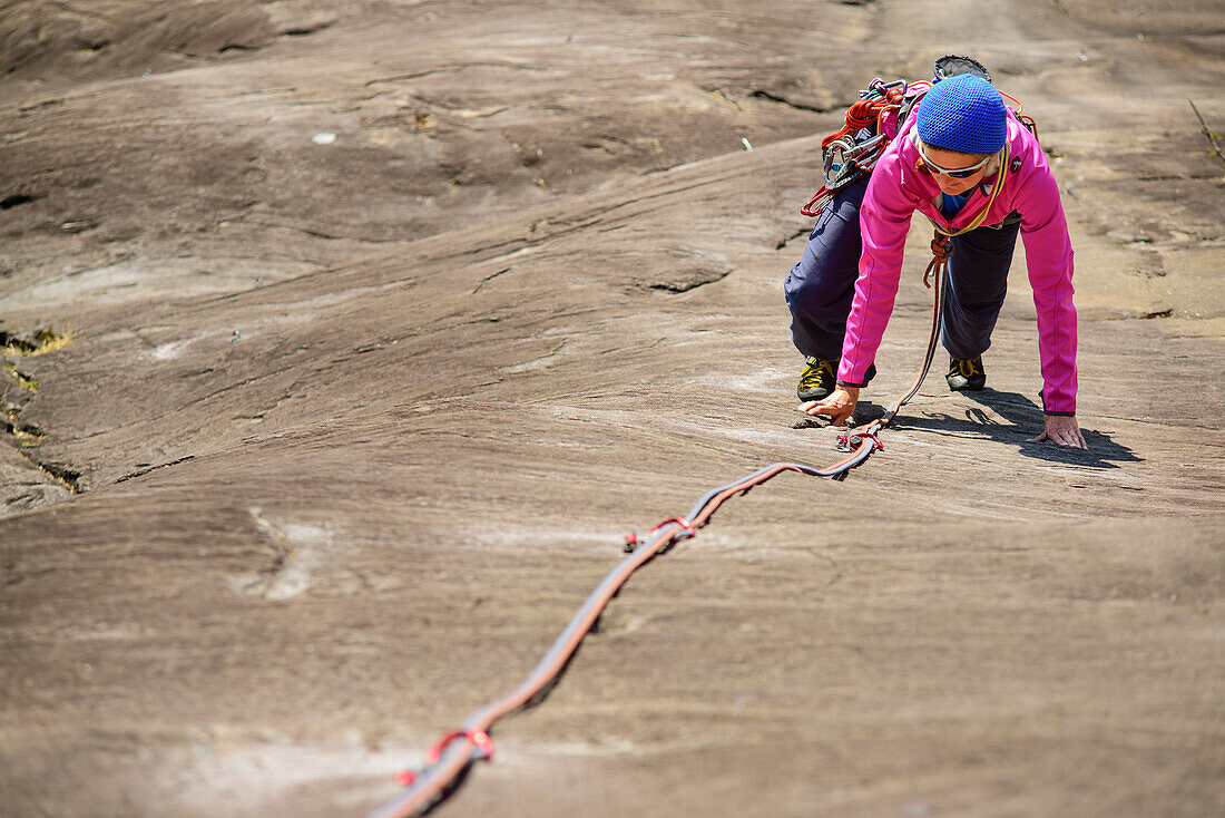 Woman climbing on Gneiss rock, Placca di Tegna, Ponte Brolla, Ticino, Switzerland