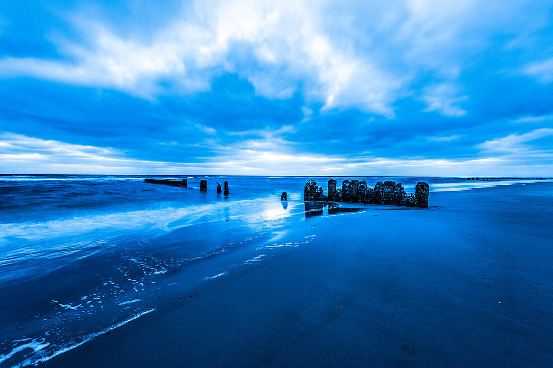 Groynes at beach in twilight, Kampen, Sylt, Schleswig-Holstein, Germany