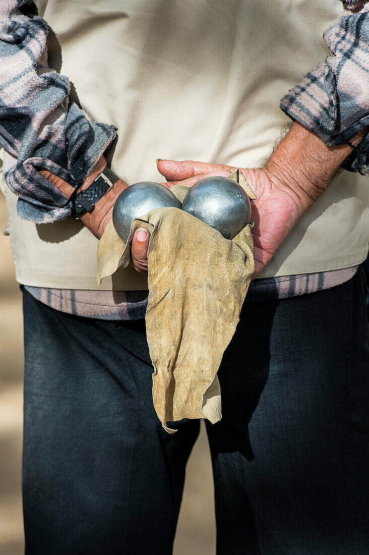 Senior bocce player awaits his turn to throw.