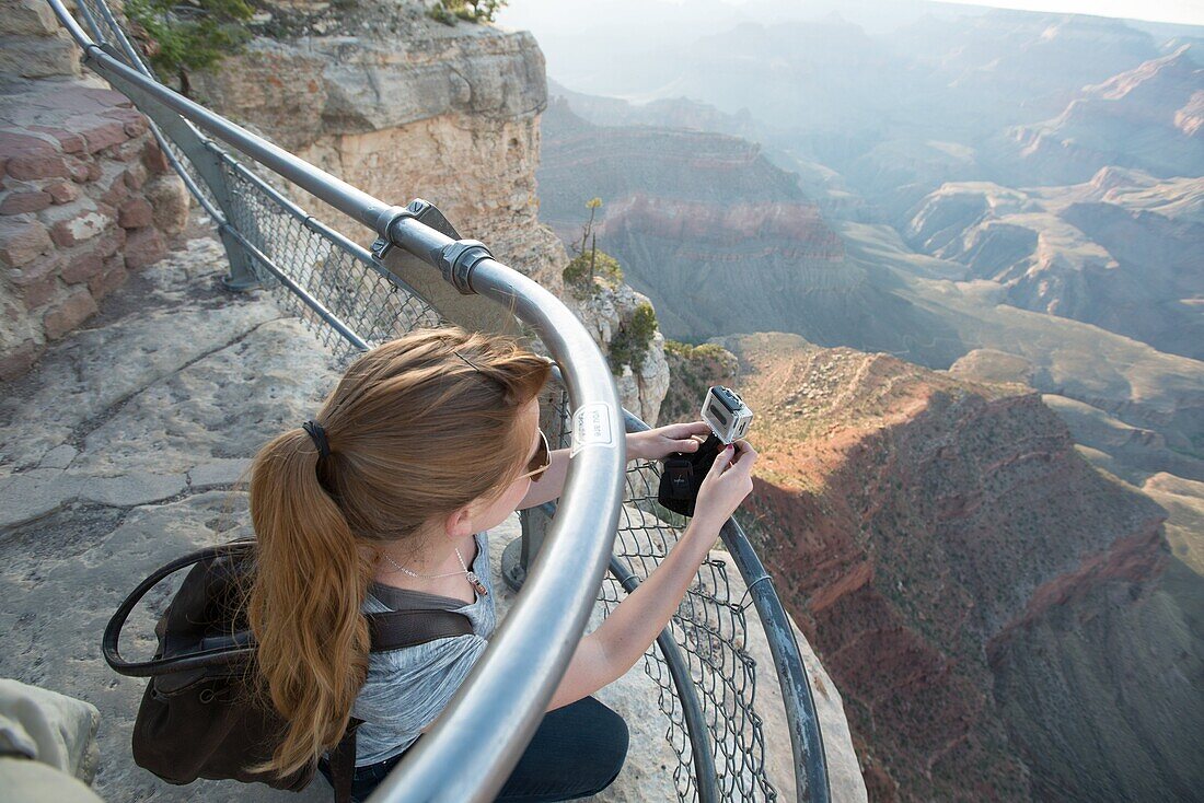 young woman documenting the Grand Canyon.