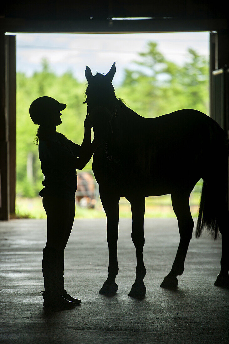 Woman and horse silhouette. Orono Maine USA