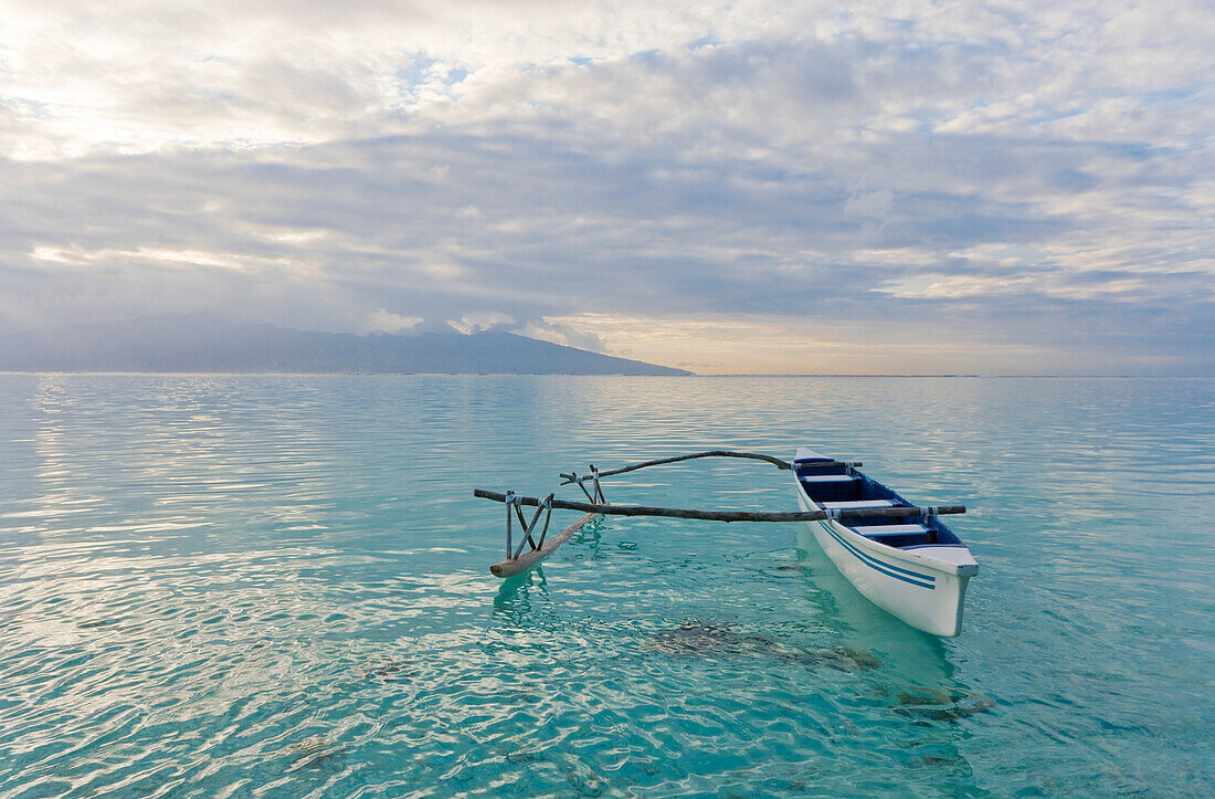 French Polynesia, Moorea, Outrigger Canoe On Calm Ocean Water.