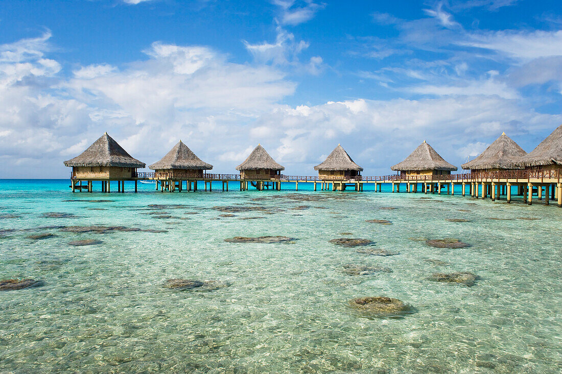 French Polynesia, Tuamotu Islands, Rangiroa Atoll, Luxury Resort Bungalows Over Ocean.