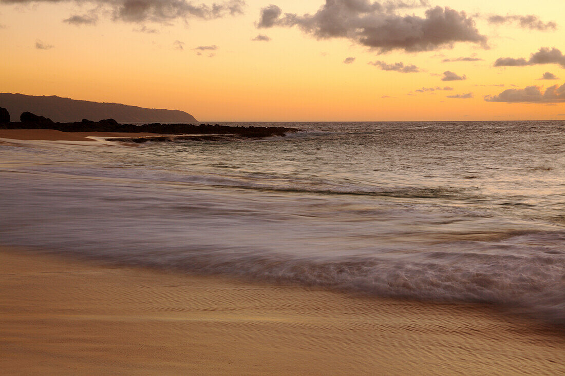 Hawaii, Blur Of Waves Crashing On The Beach At Sunset