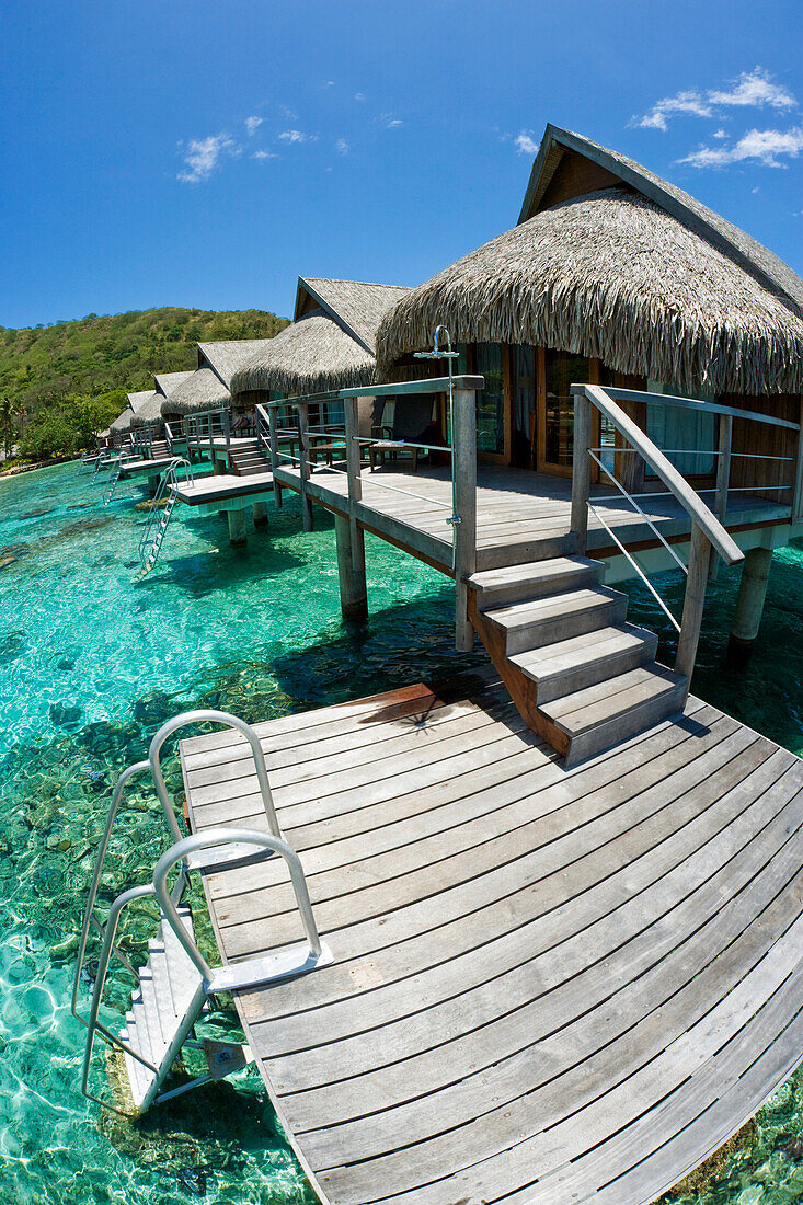 French Polynesia, Moorea, Luxury Resort Bungalows Over Ocean.