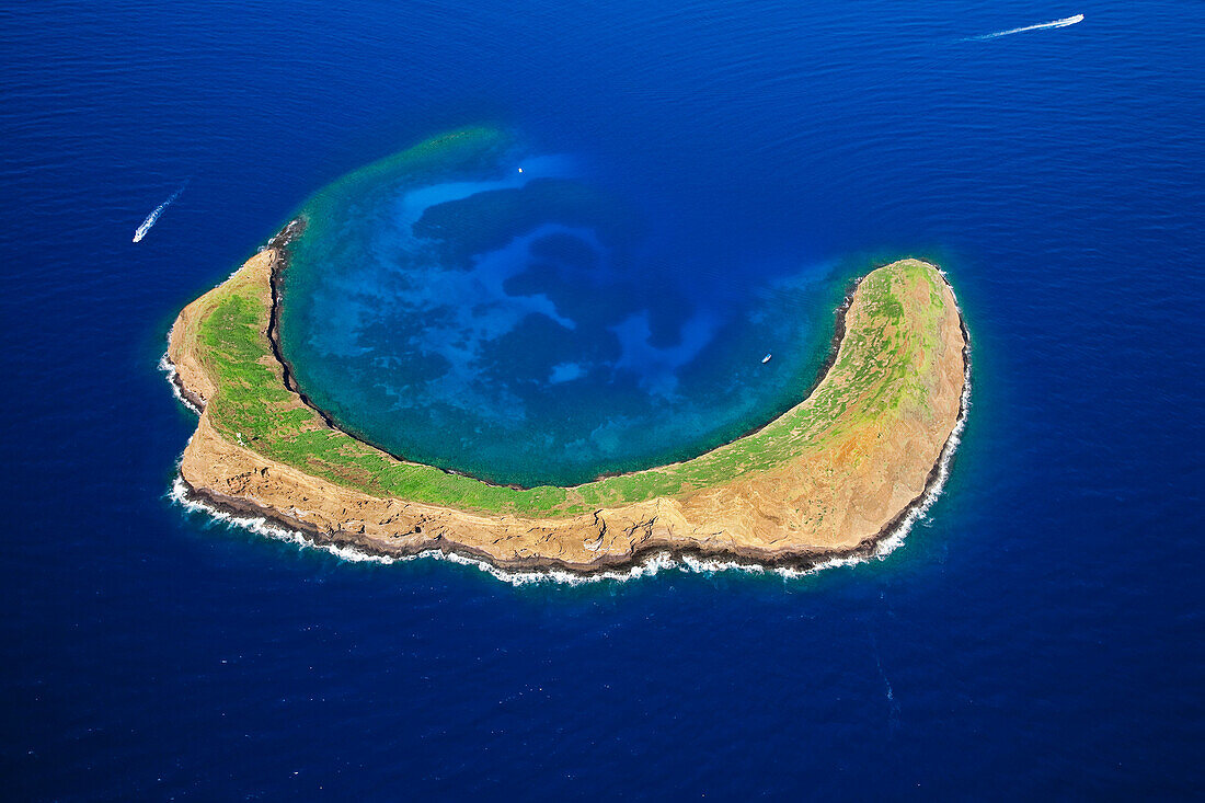 Hawaii, Maui, Molokini, Aerial Shot Of The Crescent Shaped Islet From Behind, Maui In Distance.
