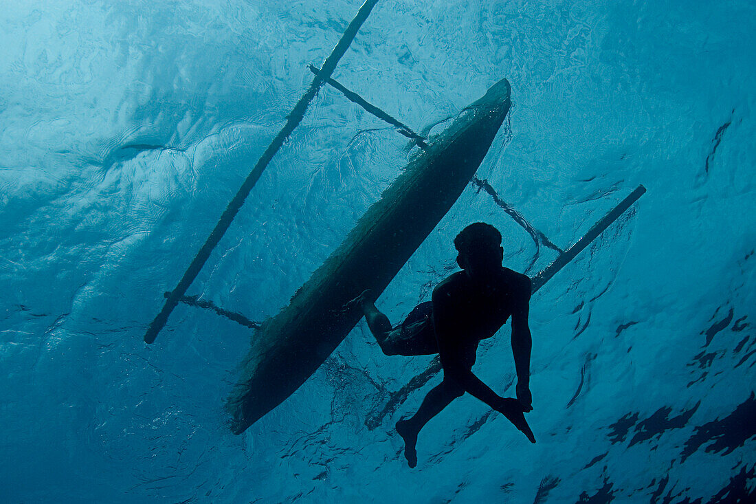 Indonesia, Pura Island, Native Freediver Swims Down From His Canoe, View From Below.