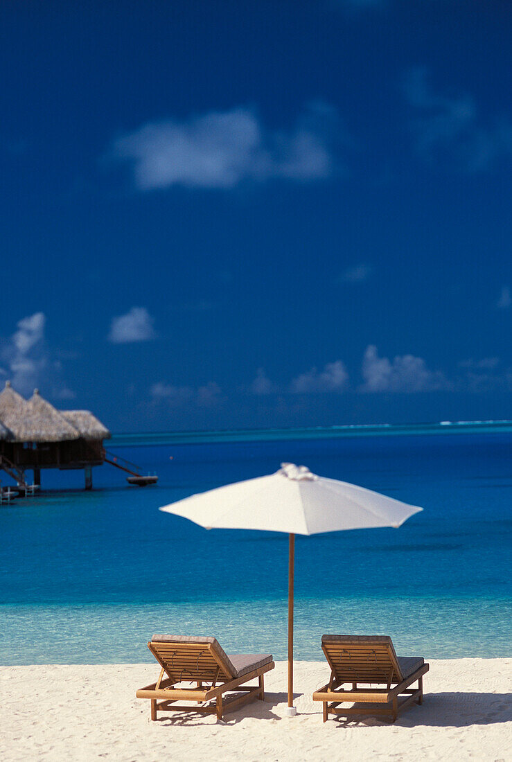 French Polynesia, Bora Bora, Chairs And Umbrella On Deserted Beach, Blue Sky, Water, White Sand