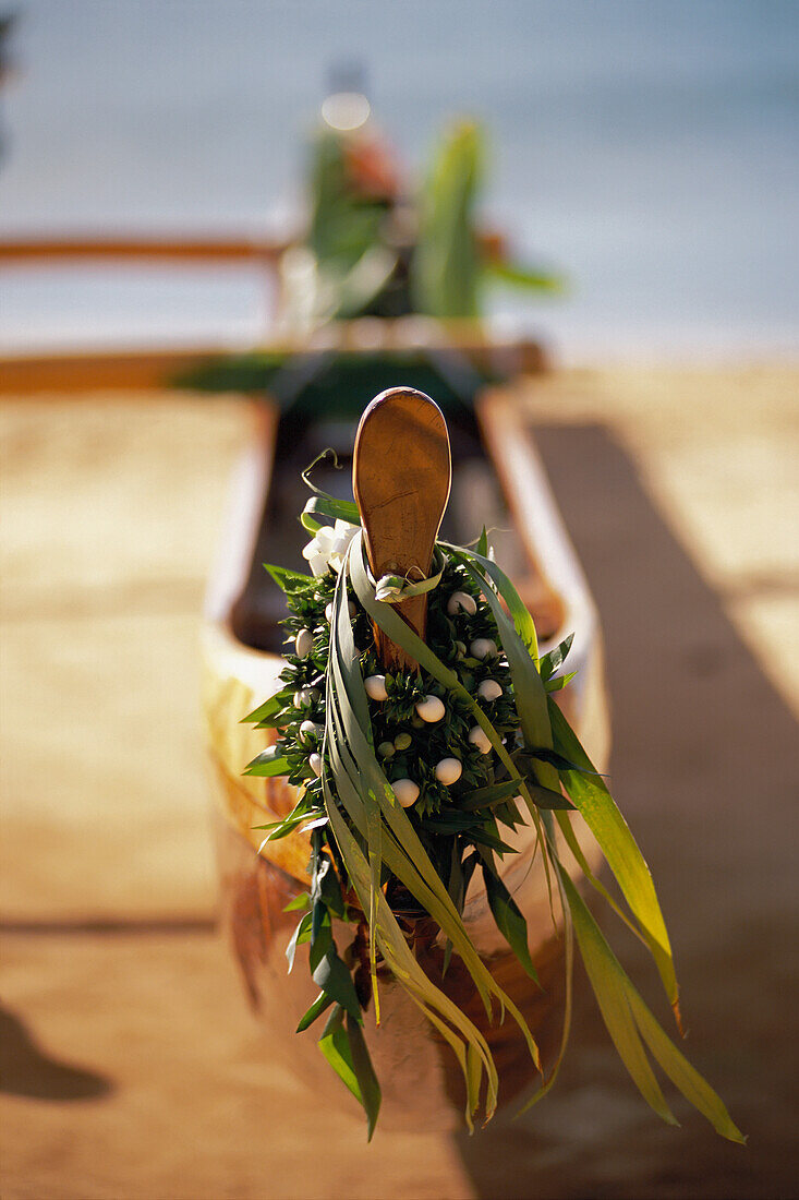 Koa Canoe With Ti Leaf And Kukui Nut Leis On Hull Afternoon Light Selective Focus Blurry Background D1465