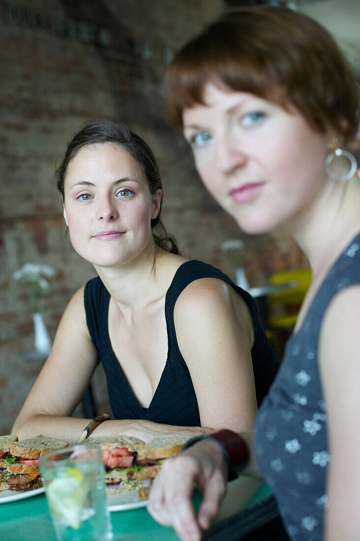 Women Having Sandwiches At Restaurant