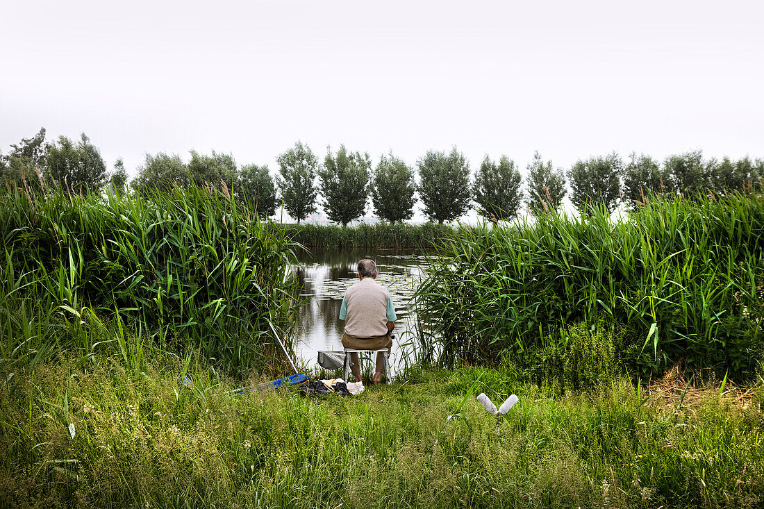 A Man Fishing In A Canal, Holland