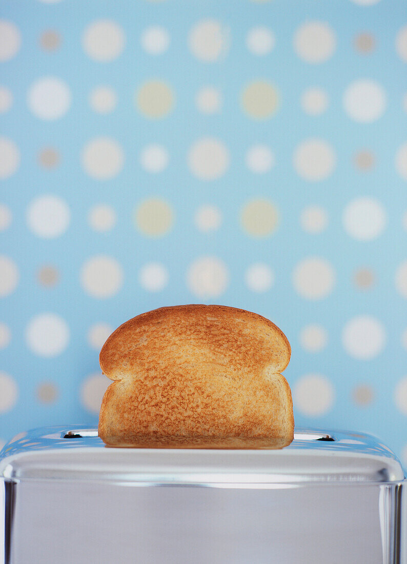 Toast In A Toaster With A Spotted Wallpaper Background