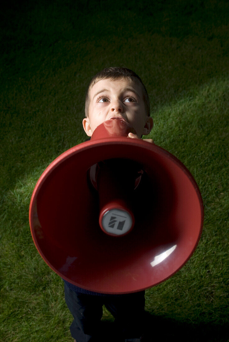 Little Boy Yelling Into A Megaphone