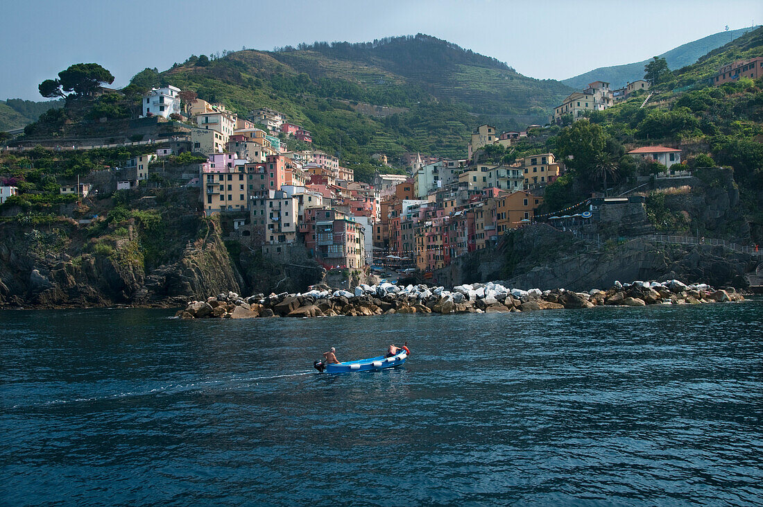 Two Local Fisherman In The Bay Of Riomaggiore Cinque Terre Region In Western Italy.