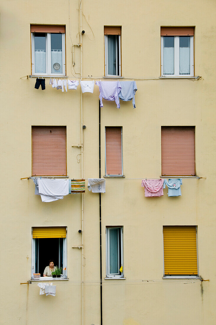 An Italian Woman Pulls Clean Laundry Off Her Clothesline, Corniglia, Cinque Terre, Italy