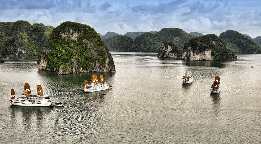 traditional junks sailing in Halong Bay, Vietnam.