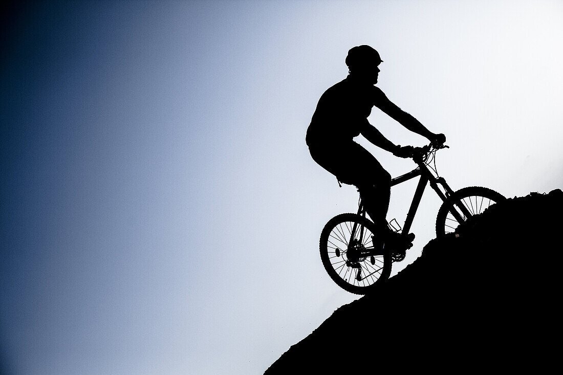 Silhouette biking btt decline in the Sierra de Cazorla, Andalucia, Spain