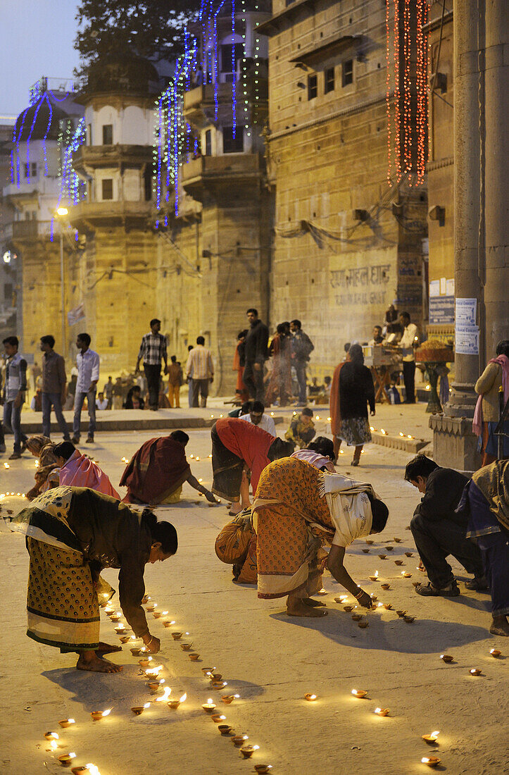 India, Uttar Pradesh, Varanasi, Dev Deepawali festival, Hindu devotees lighting oil lamps.