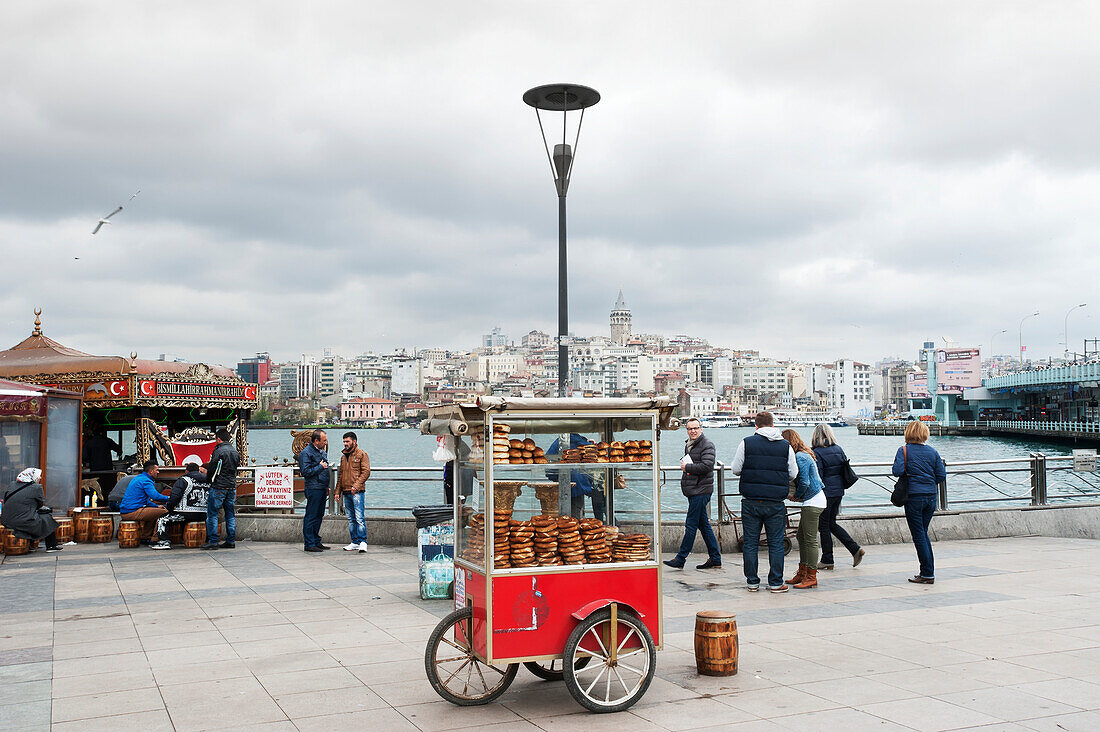 'Food cart and pedestrians at the waterfront; Istanbul, Turkey'
