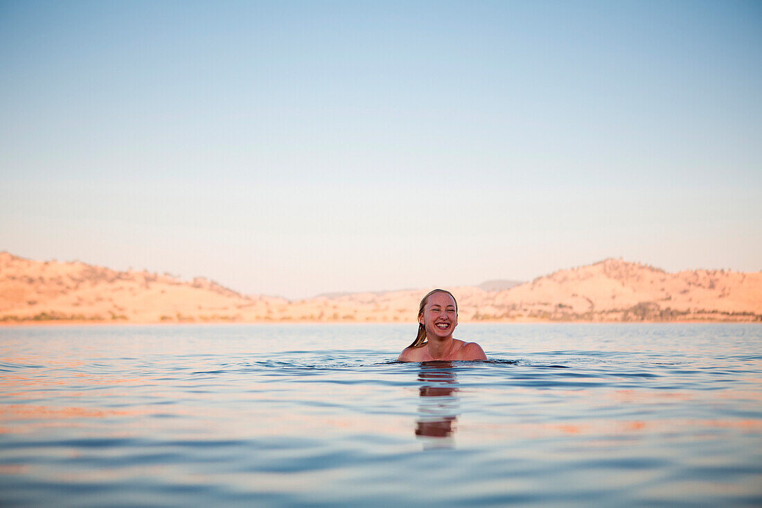 'A woman swims in Lake Hume; Riverina, New South Wales, Australia'